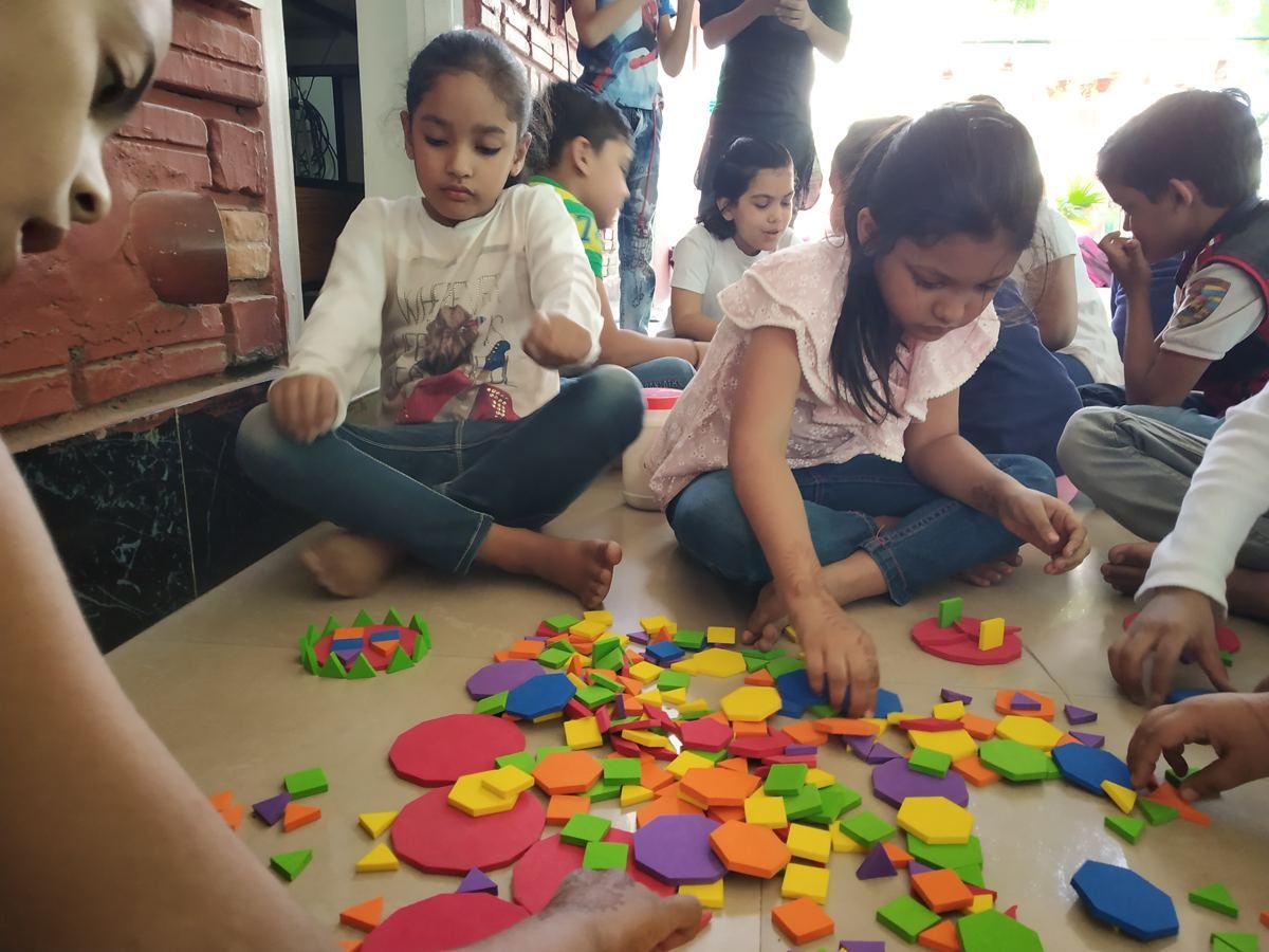 Children sorting coloured shapes together